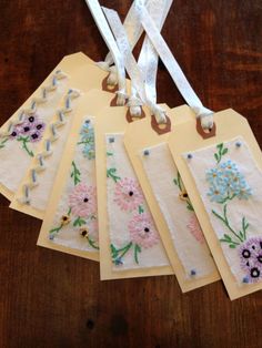 five handmade tags with flowers on them