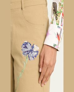 Libertine "Cecil Beaton" pants with crystalembellished blue carnations    Approx.  25" inseam    Cropped fit    Mid rise sits high on hip    Wide legs    Fivepocket style    Button/zip fly; belt loops    Cotton/elastane    Dry clean    Made in USA Embellished Spring Bottoms, Embellished Spring Trousers, Spring Embellished Straight Leg Bottoms, Embellished Straight Leg Bottoms For Spring, Blue Carnations, Cecil Beaton, Cropped Wide Leg Pants, Wide Legs, Wide Leg Pants