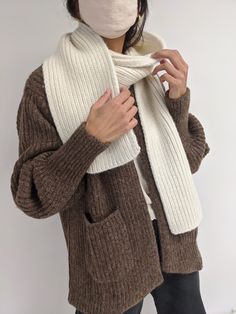 The CeCe Scarf is an exquisite piece knit from silky, dense baby alpaca yarn. It pairs perfectly with the Frankie Hat but can be worn in a variety of ways. Versatile and timeless, the CeCe scarf will become a staple in your cool-weather wardrobe, meant to be cherished for years to come. Ivory: Cream Oat: Tan Umber: Brown Ash: Grey Sky: Blue Onyx: Black 70% Baby Alpaca / 7% Merino Wool / 23% Synthetic Made in Peru Measurements: OS: 72” length / 8”width Full priced items purchased with a promotion Cream Wool Scarf For Fall, Beige Knitted Scarves One Size, White Knitted Scarf For Fall, One Size Beige Knitted Scarves, Cozy Hand-knitted Alpaca Scarves, Beige Knitted Scarves, White Wool Scarves For Winter, White Wool Scarf For Winter, Cream Winter Scarf One Size