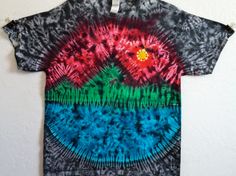 a tie - dyed t - shirt hanging on a wall