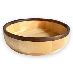 a wooden bowl is shown on a white background with wood grain in the bottom and sides