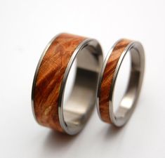 two wedding rings with wood inlays on them