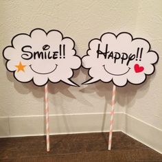 two white clouds with the words smile and happy on them are standing next to each other