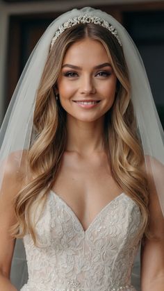 a woman wearing a wedding veil and smiling at the camera with her hands on her hips