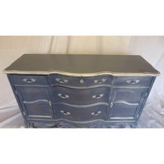 an old dresser painted in blue and white