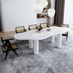 a large white table with chairs around it in a living room next to a window