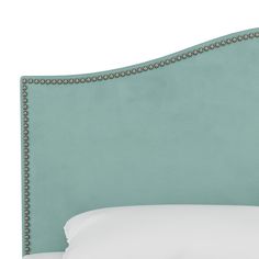 an upholstered headboard with studded trim