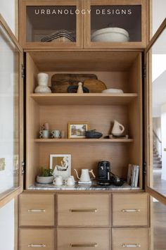 an open cabinet with many items on it and the words urbanlogy designs above it