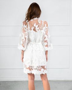 If she said yes, and you've got some getting ready to do for her wedding, then you can't let her miss a beat for a great photo opportunity than having her wear this Full Lace Floral Bridal Robe. Great for a white wedding theme, this full lace robe is an elegant robe for bride that she will look back at fondly for years to come. Inner Slip included for extra coverage! This lace robe is not only beautiful, but it is also stunning with its kimono robe cut and full floral lace pattern. This bridal r White Lace Gown For Wedding Night, White Lace Bridal Accessories For Bride, White Lace Bridal Accessories, White Bridal Accessories With Lace Trim, White Lace Bridal Accessories For Bridal Shower, White Lace Trim Wedding Dress For Bridal Shower, White Lace Trim Gown For Bridal Shower, White Wedding Dress With Lace Trim For Bridal Shower, White Gown With Lace Trim For Bridal Shower