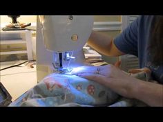 a person using a sewing machine to sew something