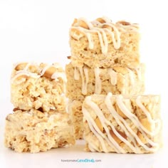 four pieces of rice krispy treats stacked on top of each other with icing