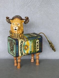 a lion figurine sitting on top of a box