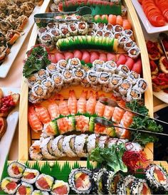 an assortment of sushi on display in a boat