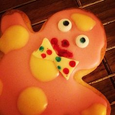 a decorated cookie with eyes and a piece of pizza in the shape of a bear