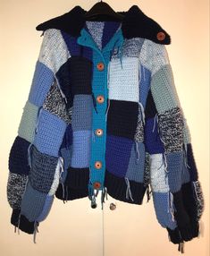 a multicolored jacket hanging on a coat rack