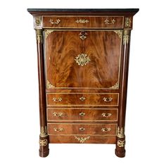 an antique chest of drawers with gold trimmings