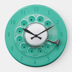 a green clock with black numbers on the face