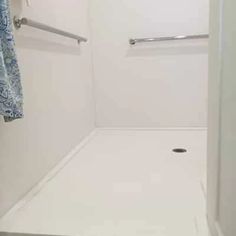 a bathroom with a shower, toilet and towel rack