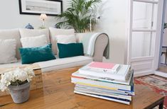 a living room filled with furniture and lots of pillows on top of it's wooden table