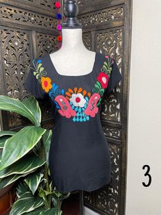 "A very nice and beautiful Sunflower Blouse w/Gorgeous Embroidery. The design work is simply gorgeous. Perfect for your ultimate weekend look, beach, casual look or just to impress your friends with this gorgeous piece. You will Love it! Blouse STYLE DETAILS Overview * Round neck * Handmade work * 3/4 Long sleeves * 22\" UNDERARM TO UNDERARM, 30.5\" SHOULDER TO HEM fabric & care * hand wash * delicate care * hang dry Please email me your questions before buying email me TODAY All of my items Summer Blouse With Floral Embroidery And Short Sleeves, Summer Vacation Blouse With Embroidered Neckline, Summer Vacation Embroidered Top, Summer Floral Embroidery Top For Beach, Black Embroidered Summer Blouse, Black Summer Blouse With Geometric Embroidery, Fitted Embroidered Beach Top, Black Blouse With Geometric Embroidery For Summer, Summer Embroidered Top With Floral Design For Vacation