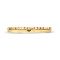 This elegant 10K gold band features a polished edge and is adorned with 1/20 CT. T.w. diamonds for a touch of sparkle. 10K gold. Polished edge design. 1/20 CT. T.w. diamonds. 14k Gold Bands With Diamond Accents, Timeless Yellow Gold Bands With Diamond Accents, Classic Gold Eternity Band With Pave Setting, Timeless Yellow Gold Channel Set Diamond Ring, Yellow Gold Eternity Band With Pave Setting, Timeless Yellow Gold Diamond Band, Classic 14k Gold Eternity Band With Pave Setting, Gold Diamond Ring With Channel Set, Classic 14k Gold Bands With Diamond Accents