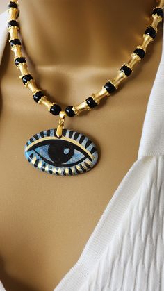 Large Handmade Ceramic Evil Eye Necklace  , Natural Stone jewelry  , black onyx ceramic evil eye necklace  Handmade ceramic necklace  with gold... Necklace :17 inch long with 3 inch chain total can be 20 inch Symbolic Black Necklace With Adjustable Chain, Black Bohemian Jewelry With Evil Eye, Black Bohemian Evil Eye Jewelry, Black Evil Eye Spiritual Necklace, Black Spiritual Necklace With Evil Eye Detail, Black Spiritual Necklace With Evil Eye, Spiritual Black Evil Eye Necklace, Handmade Gold Onyx Necklaces, Ceramic Evil Eye