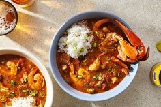 two bowls of seafood and rice on a table