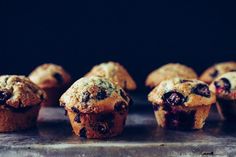 blueberry muffins lined up on a baking sheet