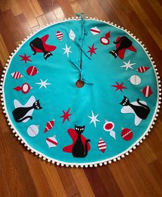 a clock made out of fabric on the floor with stars and other things around it