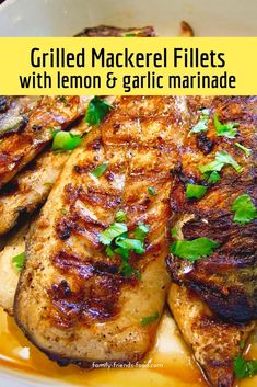 grilled mackel fillets with lemon and garlic marinade in a white bowl