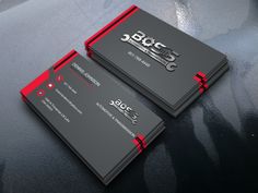 two black and red business cards sitting on top of a gray surface with the words abcc