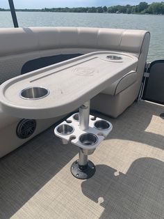 the back end of a boat with two cup holders on it's center console