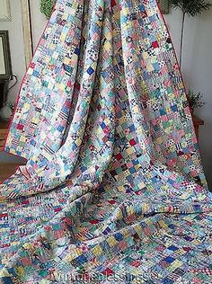 a colorful quilt is draped in front of a mirror