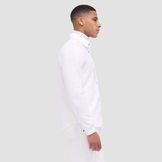 Made from a luxurious soft-touch knit fabric, this performance shirt jacket offers exceptional comfort and style. It features a point collar, full snap closure, ribbed cuffs, zippered side pockets, and sleek nylon trimming. Combining practicality with modern sophistication, this shirt jacket is a great choice for both casual and activewear. Classic White Outerwear With Spread Collar, Modern Track Jacket With Ribbed Cuffs, Modern Long Sleeve Track Jacket With Ribbed Cuffs, Casual White Outerwear With Spread Collar, Workwear Track Jacket With Ribbed Collar And Long Sleeves, Business Outerwear With Ribbed Cuffs And Long Sleeves, Classic Long Sleeve Sport Coat With Ribbed Cuffs, Business Casual White Outerwear With Button Cuffs, Modern White Outerwear With Concealed Placket