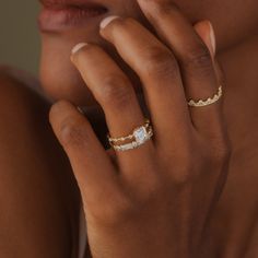 a close up of a woman's hand with a ring on her finger