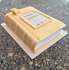 a book shaped cake sitting on top of a table