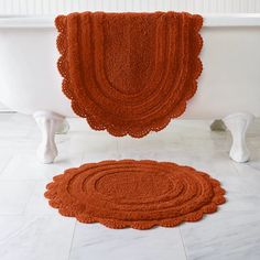 an orange rug is on the floor next to a bathtub