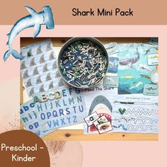 there is a shark and other items on the table with it's name underneath