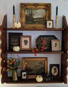 the shelves are filled with pictures and other decorative items, such as pumpkins or flowers