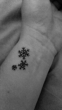 a snowflake tattoo on the wrist