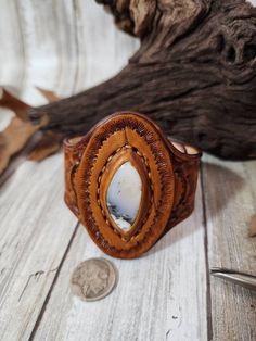 Check out this item in my Etsy shop https://www.etsy.com/listing/1390418259/dendrite-opal-tooled-leather-cuffstone Vintage Hand-tooled Brown Jewelry, Rustic Hand Tooled Leather Jewelry, Vintage Brown Hand-tooled Jewelry, Southwestern Hand-tooled Brown Bracelets, Hand Tooled Brown Cuff Jewelry, Rustic Brown Cuff Bracelet With Concho, Artisan Carved Brown Jewelry, Artisan Brown Carved Jewelry, Brown Leather Engraved Jewelry