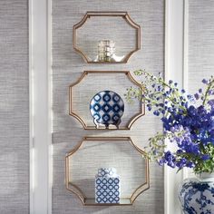 three shelves with blue and white vases on them