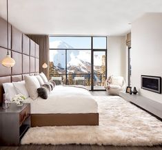 a bedroom with a large bed and a view of the mountains