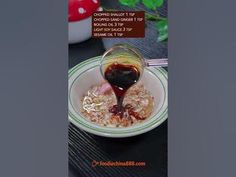 a bowl filled with oatmeal and sauce on top of a wooden table