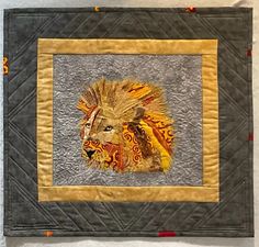 Collage Art Quilt of Lion of Botswana by Marcia Birken; Marcia Birken discovered quilting after a career as a math professor. Her interest has always been discovering patterns everywhere as she traveled the world. You’ll find influences of both her travels and exploration of patterns in her art quilts.