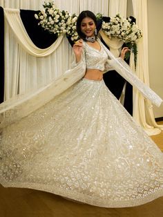 Step into a world of enchantment and elegance with our Parneet Lehenga. This exquisite lehenga is designed to make you feel like royalty, with its intricate mirror, pearl, and stone embellishments. Crafted with the utmost attention to detail, this lehenga showcases the perfect blend of tradition and contemporary style. Key Features: Pearl White Color Silk blouse with mirror, pearl, stone, and embroidery work Soft net lehenga with mirror, pearl, stone, and embroidery work Soft net dupatta with em Traditional Drape Sets With Pearl Embroidery For Wedding, Wedding Traditional Wear With Pearl Embroidery, Traditional Drape Wedding Sets With Pearl Embroidery, Festive Wedding Dress With Dupatta For Party, Festive Party Wedding Dress With Dupatta, Elegant Traditional Wear With Sheer Dupatta And Kundan, Elegant Silver Choli For Diwali, Floor-length Choli With Sheer Dupatta For Wedding, Wedding Choli With Pearl Embroidery And Traditional Drape