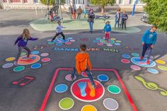 children are playing in an outdoor playground with painted circles