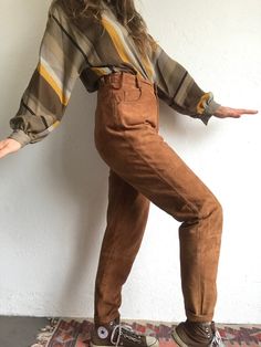 "Vintage tapered suede pants Made in Germany 1980 Tan leather high waist pants . Wide at the thighs and smaller at the ankle. Button and zipper 5 pockets. 6 belt loops. Garanty label (leather) inside. Lined. In very good condition. 100% genuine leather 100% Polyester (lining) Estimated size EU 40 - UK 8 - US 12 Model wears usually size S (US pants 26) and measures 170cm/ 66,9\". This pants are too big for her. Flat measurements (flat) : Waist: 36cm - 14,1\" Hips: 52cm - 20,4\" Length: 106cm - 41 Pucci Vintage, Suede Pants, Vintage Suede, Tan Suede, Batwing Sleeve, Sport Coat, Vintage Leather, High Waisted Pants, Trousers Women