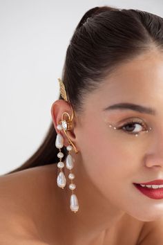 22k gold plated, 925 silver base ear cuffs handcrafted with carved work wing details, white pearls, Swarovski stones embellishment and drop long tassel details. - Aza Fashions Swarovski Stones, Jewellery Earrings, Ear Cuffs, 22k Gold, Aza Fashion, Online Jewelry, Pearl White, Ear Cuff, 925 Silver