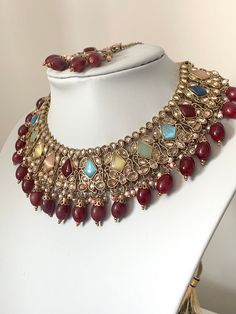 This beautiful Polki stoned multicoloured set that comes with jhumka earrings and tikka.  The earrings is multicoloured with maroon beads to add the wow factor to your outfit.  Please follow our Instagram page  @sakavano_jewellery for all our latest offers.  Please note we do not offer any refunds or exchanges due to hygiene reasons. Indian Choker, Page Instagram, Choker Set, Jhumka Earrings, Wedding Jewellery, Wow Factor, Wedding Jewelry Sets, Wow Products, Jewelry Sets